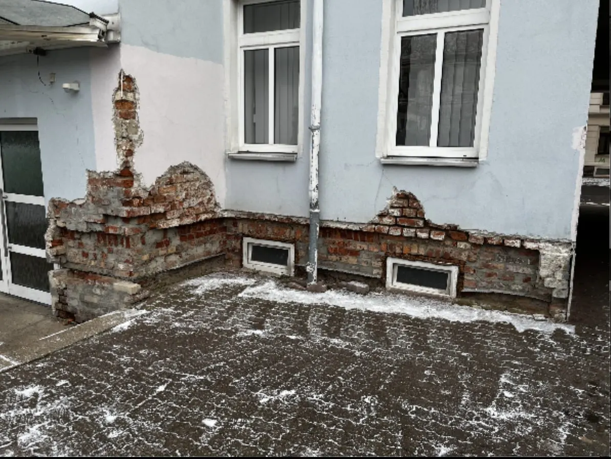Freigelegter Sockelbereich einer Fassade vor der Sanierung